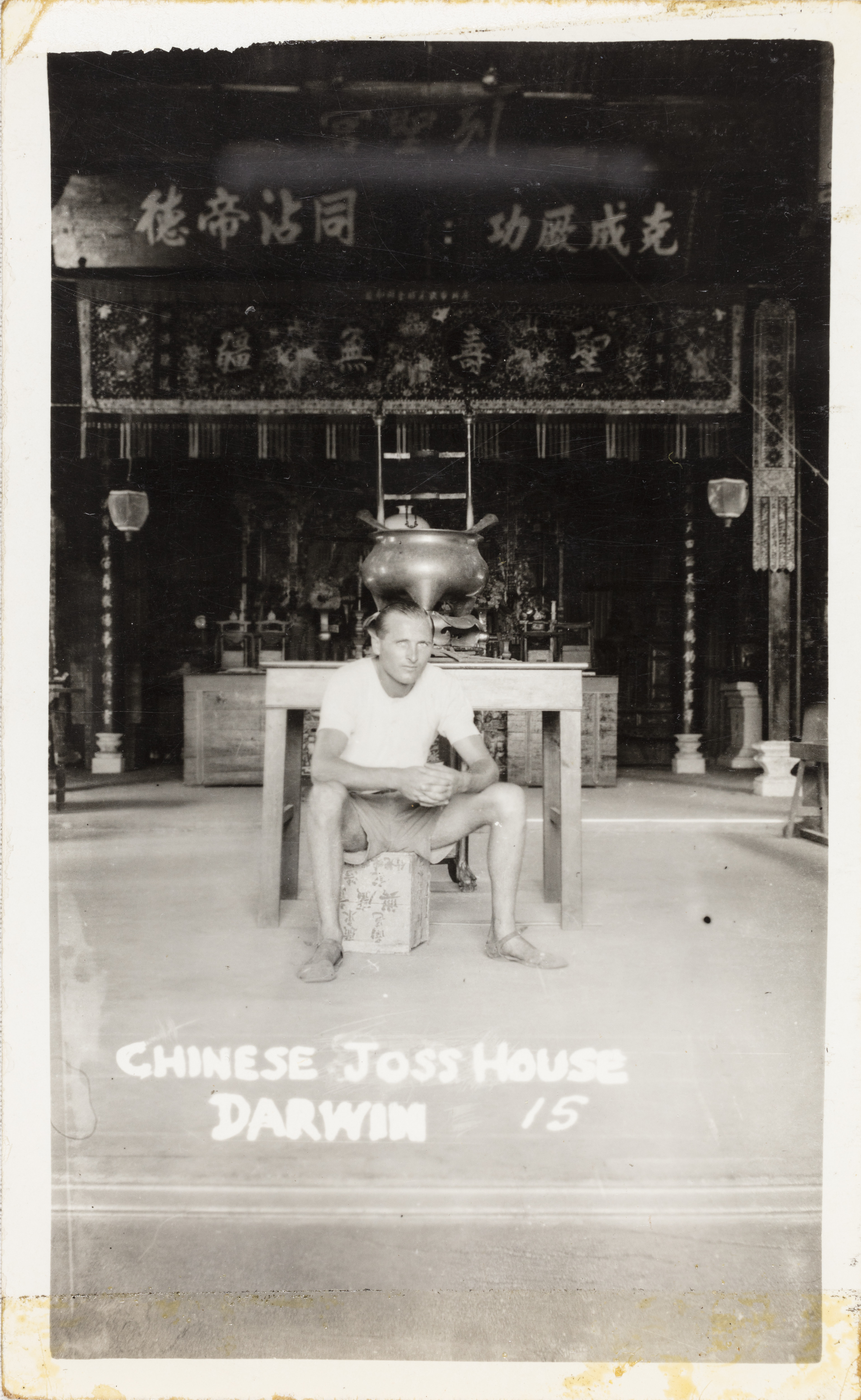 Man sitting in Darwin Chinese Joss House with Chinese