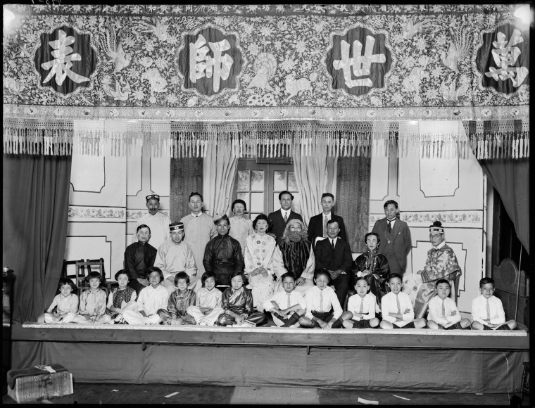 013397PD: Members of the Chinese community on a stage and in costume formal dress, probably a commemorative photo taken on China's National Day, the Double Tenth (10 October), 1930.