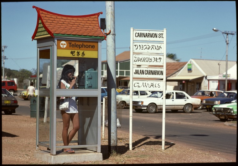 Chinese architectural style telephone box and street sign in five languages, Carnarvon Street, Broome